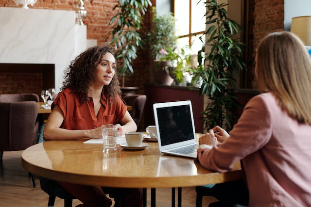 Two people in an interview at a coffee shop.