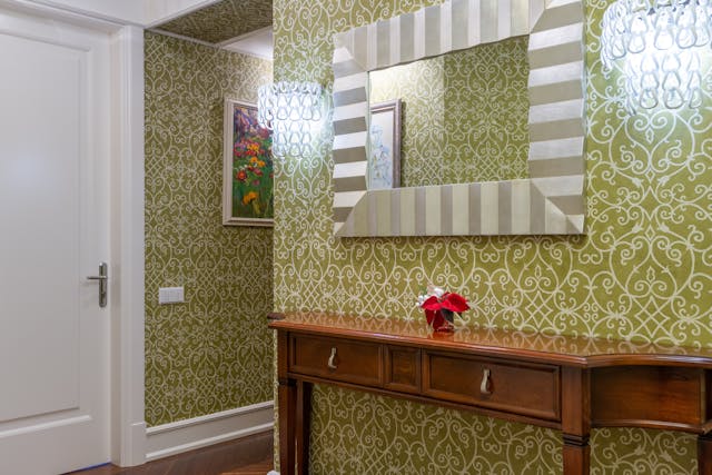 A hallway with bright wallpaper.